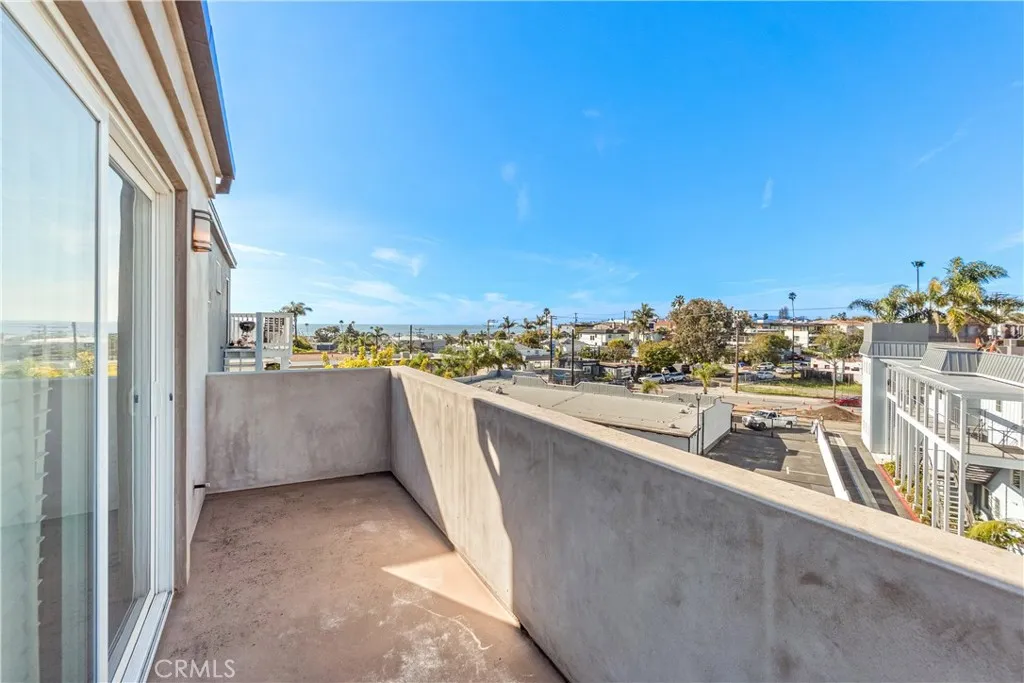 Private balcony off the primary bedroom offering ocean views and coastal breezes.
