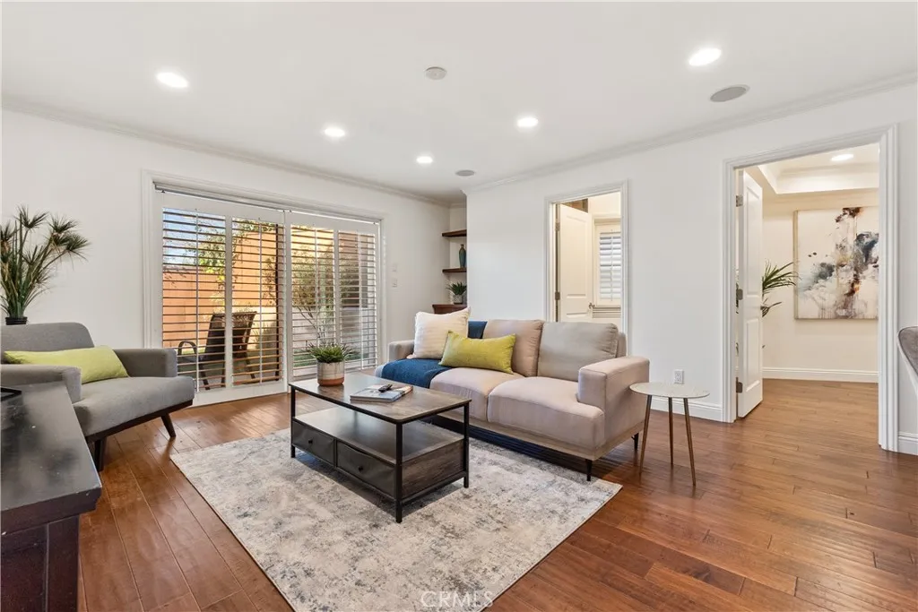 Spacious and versatile family room featuring plantation shutters, recessed lighting, and direct access to the backyard. The adjoining bonus room provides flexible space for a home office, guest room, studio, or study area, complemented by a full bath for added convenience.