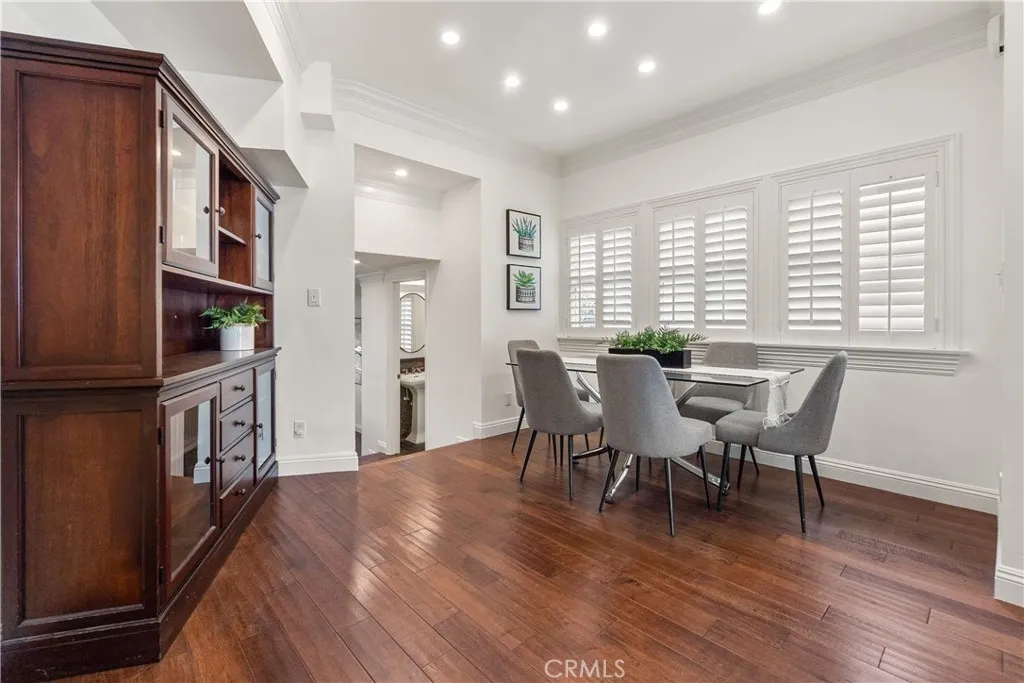 Inviting dining area with rich hardwood floors, abundant natural light, and an open connection to the main living areas.