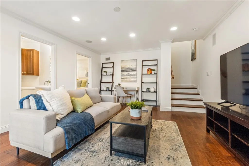 Inviting family room with plantation shutters and recessed lighting, opening directly to the backyard. This flexible living area includes a bonus room well suited for a home office, guest bedroom, studio, or study space, along with a full bath that enhances the versatility of the space.