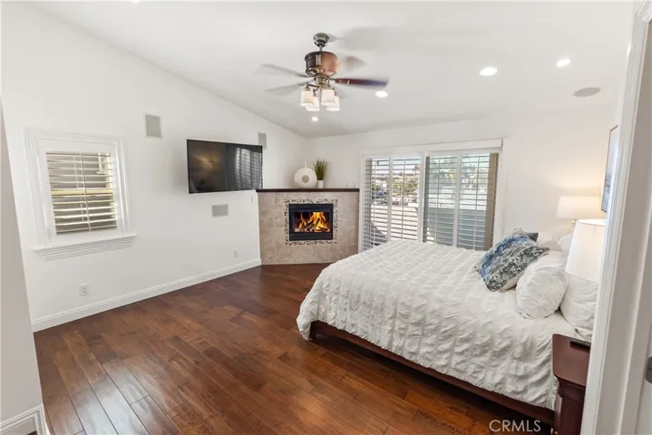 Comfortable and well-designed primary suite with fireplace, hardwood floors, and excellent natural light.