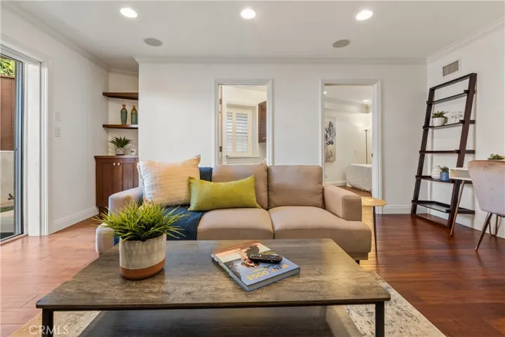 Spacious and versatile family room featuring plantation shutters, recessed lighting, and direct access to the backyard. The adjoining bonus room provides flexible space for a home office, guest room, studio, or study area, complemented by a full bath for added convenience.