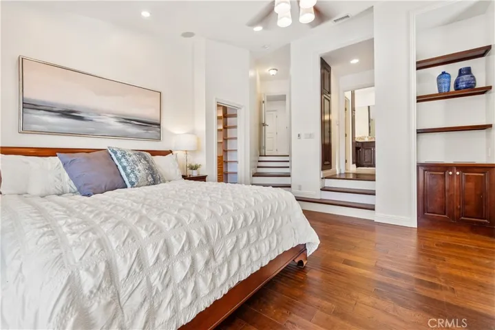 The Primary Bedroom suite is a retreat featuring beautiful built-in wood cabinetry, recessed lighting, and a spacious walk-in closet.