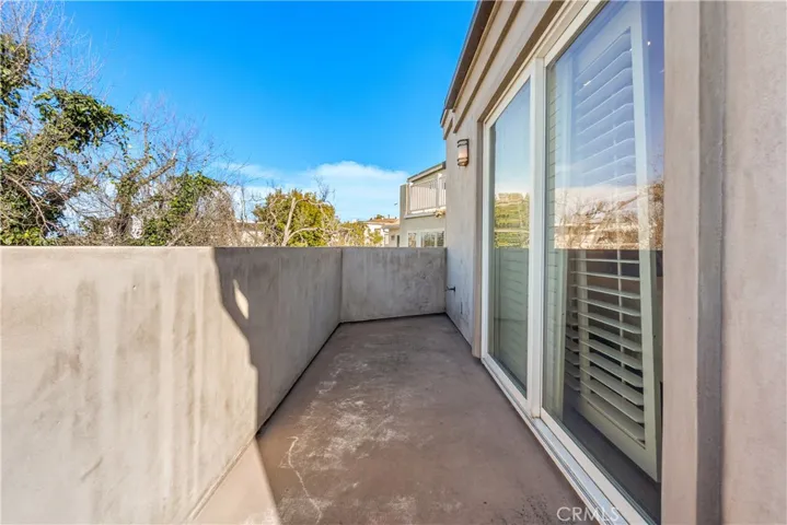 Private balcony off the primary bedroom offering ocean views and coastal breezes.