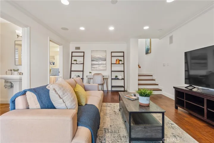 Spacious and versatile family room featuring plantation shutters, recessed lighting, and direct access to the backyard. The adjoining bonus room provides flexible space for a home office, guest room, studio, or study area, complemented by a full bath for added convenience.