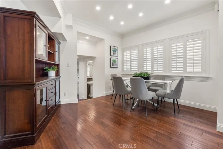 Inviting dining area with rich hardwood floors, abundant natural light, and an open connection to the main living areas.