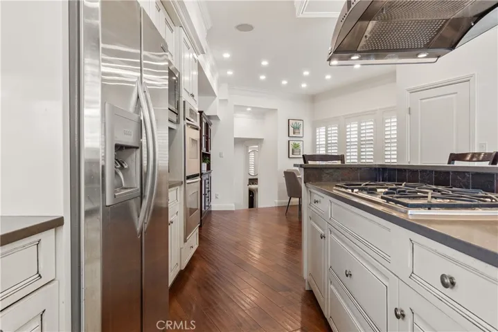 Beautifully appointed kitchen with custom cabinetry, stone countertops, and stainless appliances.