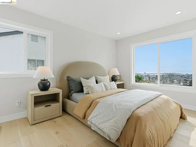 Bedroom with light wood-style floors and recessed lighting