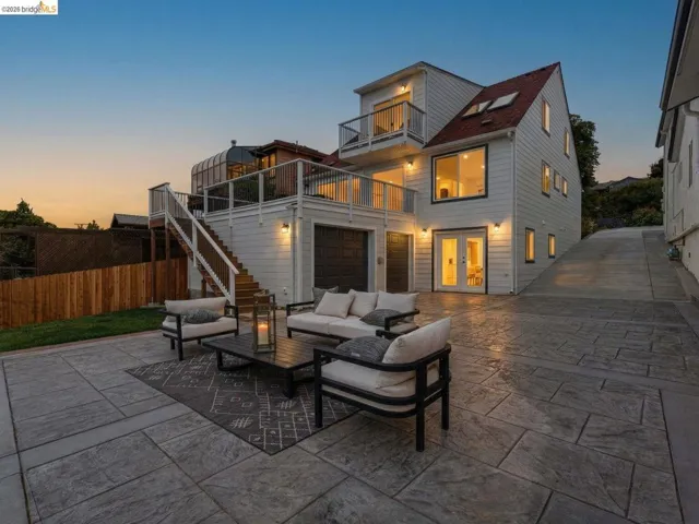 Patio terrace at dusk featuring french doors, a patio, outdoor lounge area, and a balcony