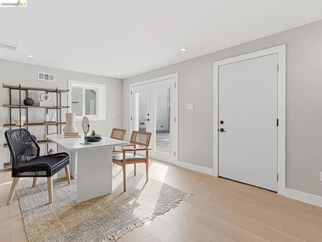 Dining room with french doors, light wood-type flooring, and recessed lighting