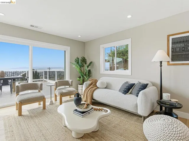 Living area with wood finished floors and recessed lighting
