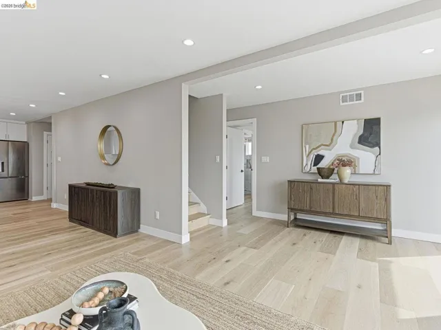 Living area with recessed lighting and light wood-style floors