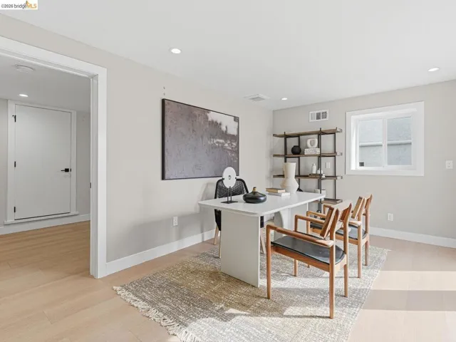 Office area with recessed lighting and light wood-style floors