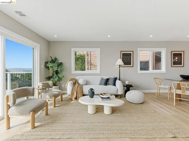 Living area featuring light wood finished floors and recessed lighting