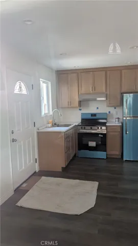 Kitchen features maple cabinets, recessed lights