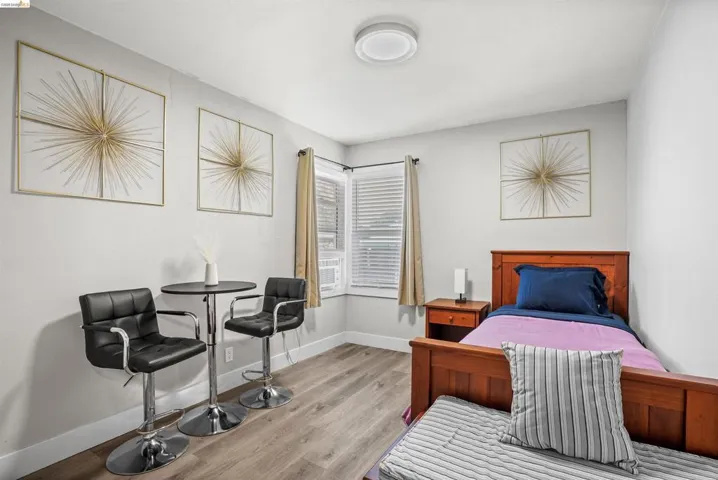Bedroom featuring light wood-type flooring and baseboards