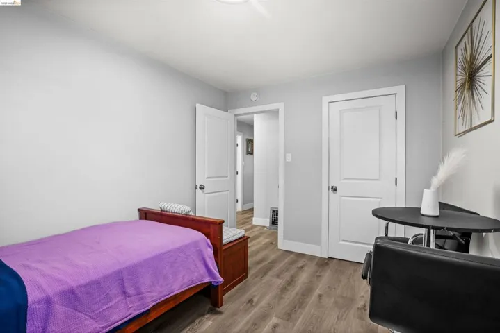 Bedroom with light wood-style floors and baseboards