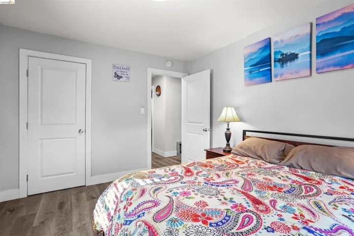 Bedroom with wood finished floors and baseboards