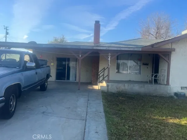 FRONT PORCH, LARGE FRONT YARD, GARAGE IS USED AS A LIVING AREA.