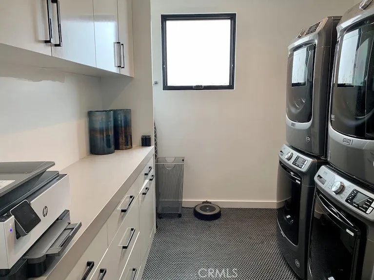 Main floor laundry room with 2 washers and dryers, including copy machine, board games