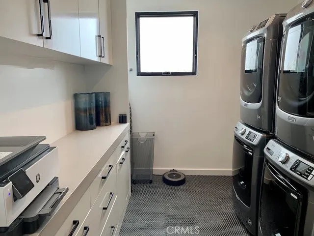 Main floor laundry room with 2 washers and dryers, including copy machine, board games