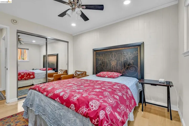 Bedroom featuring light wood-type flooring, recessed lighting, ceiling fan, and a closet