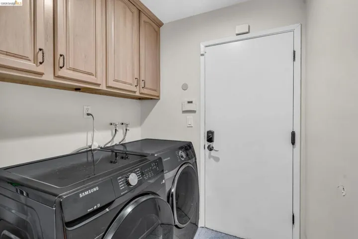 Laundry area featuring cabinet space and washer and dryer