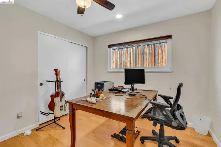 Office with light wood-type flooring, ceiling fan, and recessed lighting