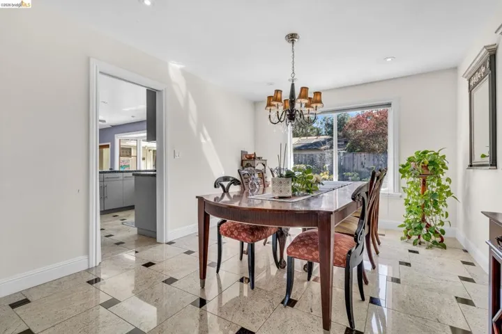 Dining space with granite floors, hanging lights, and inlaid floor details