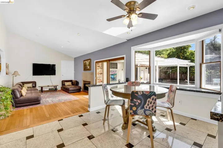 Dining space featuring ceiling fan, recessed lighting, inlaid floor details, and lofted ceiling