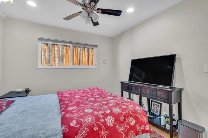 Bedroom with ceiling fan and recessed lighting