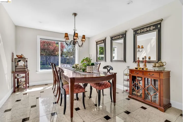 Dining area featuring granite floors and a chandelier
