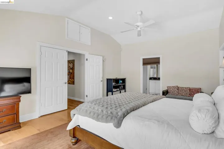Bedroom featuring lofted ceiling, light wood-style flooring, ceiling fan, and recessed lighting