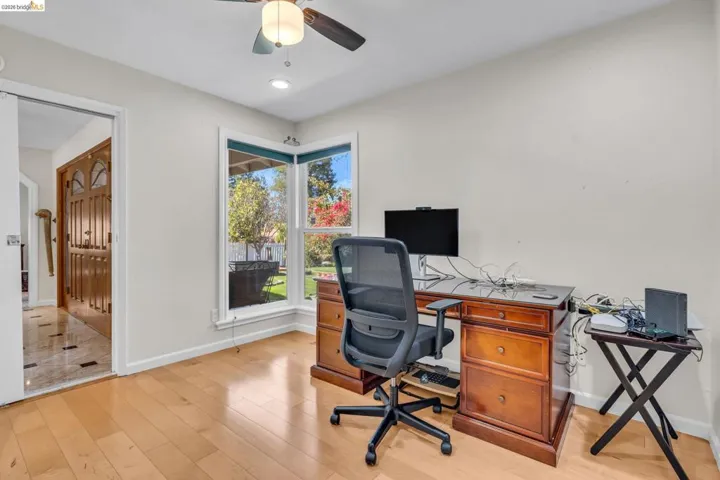 Office featuring light wood-type flooring, a ceiling fan, and recessed lighting