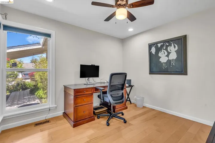 Home office featuring light wood-type flooring, ceiling fan, and recessed lighting