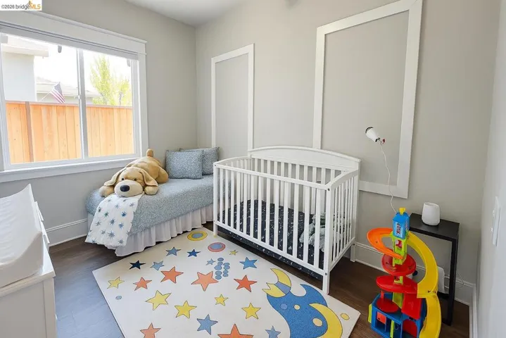 Bedroom featuring baseboards and wood finished floors