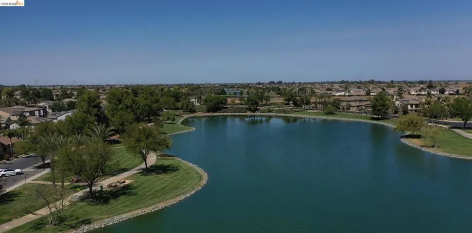 Aerial view of property's location featuring a large body of water