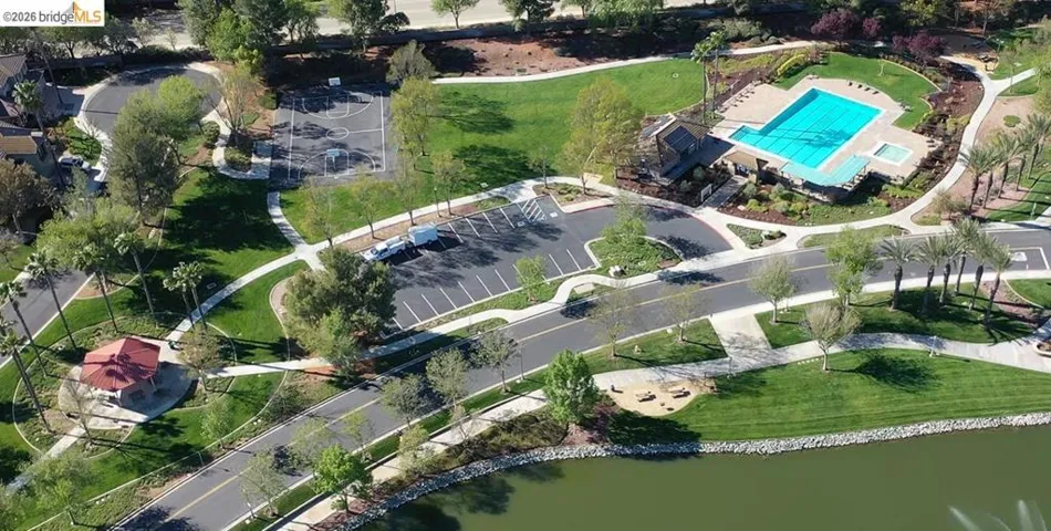 Aerial view of property and surrounding area with a pool