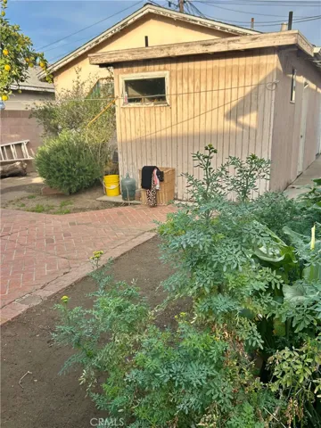 Side yard and garage with one bathroom
