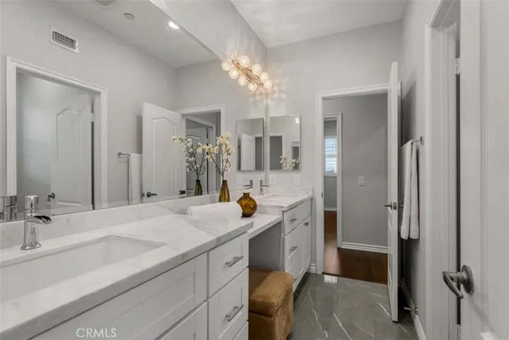 Marble counters, full-tiled walls, beveled mirrors, tempered glass shower doors, Hansgrohe fixtures and modern toilets reflect luxurious design in all bathrooms.