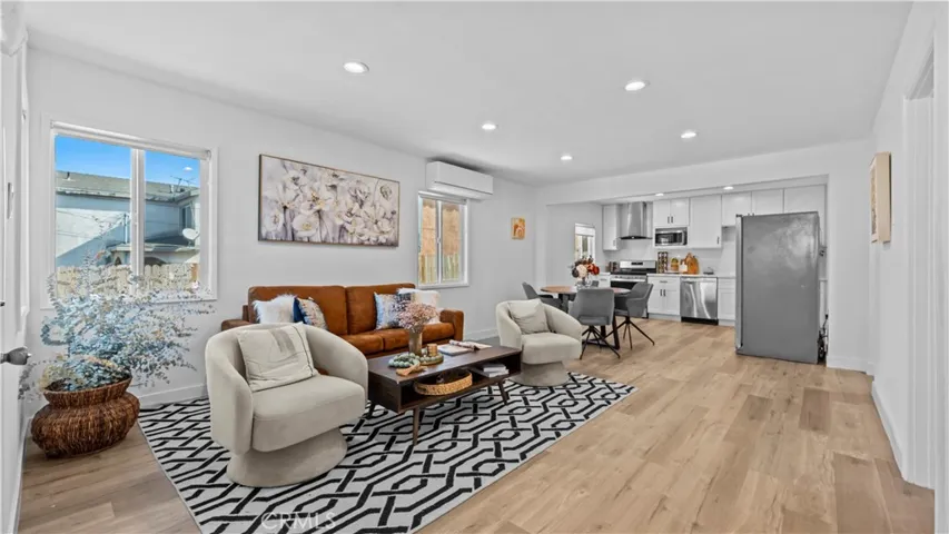 Living room leads to kitchen and dining area