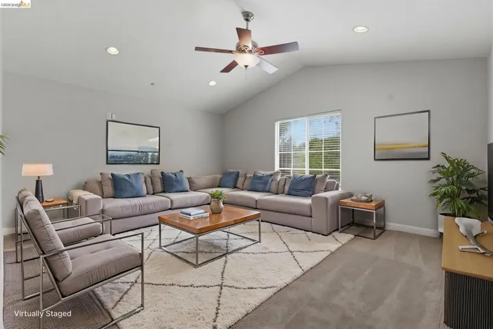 Living room featuring light carpet, a ceiling fan, and recessed lighting