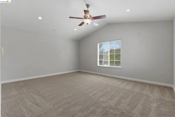 Spare room featuring light carpet, a ceiling fan, and recessed lighting