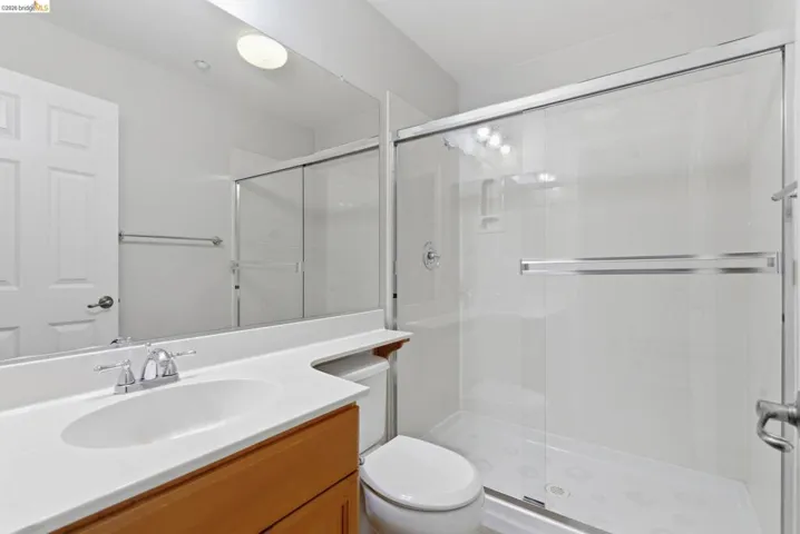 Bathroom featuring vanity and a shower stall