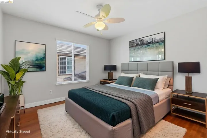 Bedroom with dark wood-style floors and ceiling fan