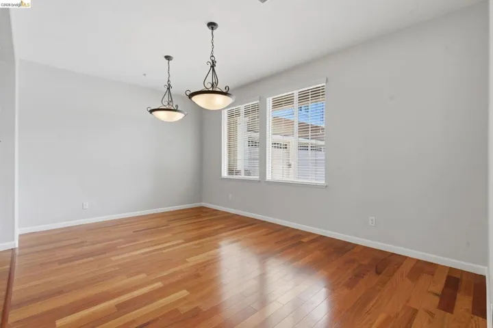 Unfurnished room featuring light wood-style flooring and baseboards