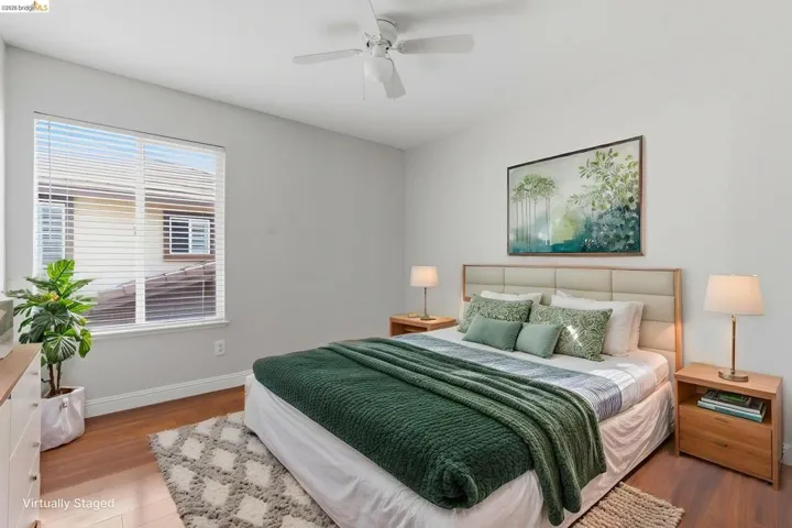 Bedroom featuring wood finished floors and ceiling fan