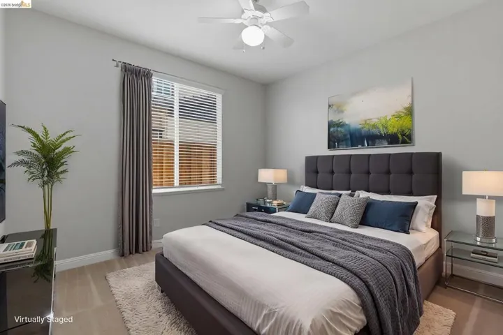 Bedroom featuring a ceiling fan and light wood-type flooring