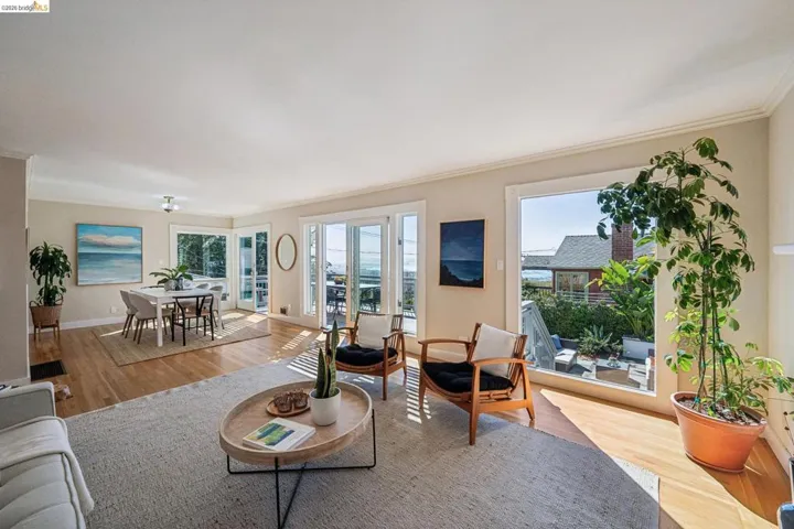 Living area with light wood finished floors and ornamental molding