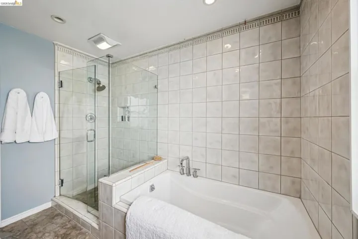 Bathroom with a garden tub and a stall shower